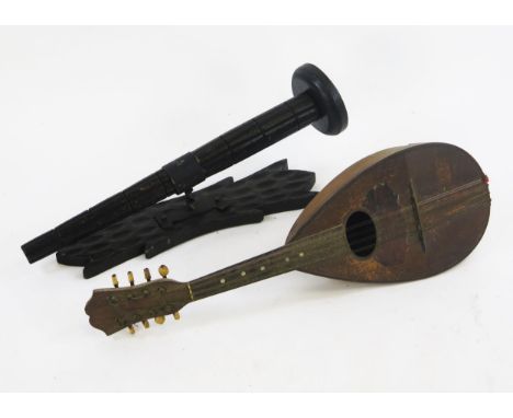 A Neapolitan eight string mandolin, together with a wood wall mounted pricket candlestick, with foliate decorated backplate.