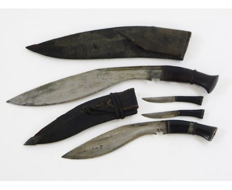 A traditional kukri with 34cm curved blade in leather sheath, togther with a smaller kukri contained in a leather sheath with