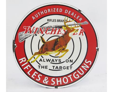 A reproduction enamel advertising sign 'Winchester Rifles and Shotguns', 31cm diameter.