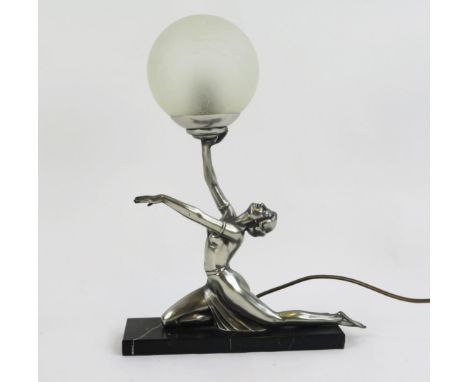 An Art Deco style 'Egyptian Moon' table lamp, the semi-naked female holding a glass globe above her head, mounted on a polish