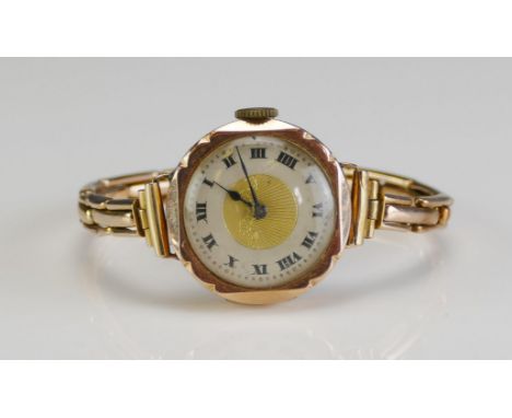 A 9ct Gold Ladies Wristwatch on a 9ct gold bracelet, 15 jewel Swiss manual wind movement, 17.43g gross. Winds and runs