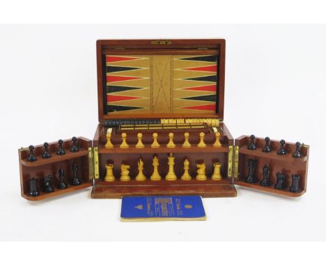 F H Ayres, a mahogany and brass bound games compendium, includes Staunton boxwood and ebonised chess set, draughts pieces, ho