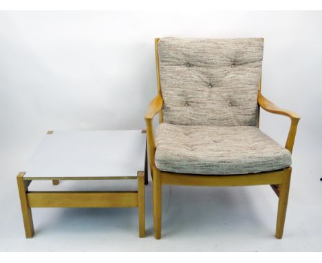 A Parker knoll armchair with button down padded cushion seta and matching coffee table. 