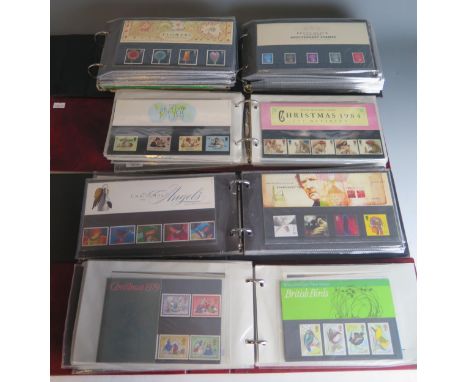 A collection of first day covers, postcards and stamp sets contained in five folders.