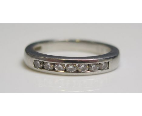 A platinum and seven stone diamond half eternity ring, 5.3gms, size K.5.