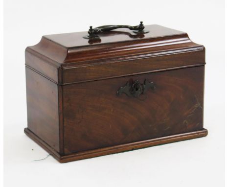 A George III mahogany tea caddy, the shallow domed top surmounted by a carrying handle enclosing three divisions to the inter