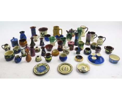 A collection of assorted Torquay and other pottery wares including jugs, vases egg cups, hat pin holder teapot, etc