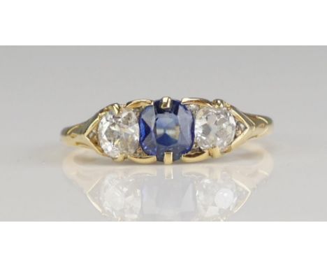 An Antique Sapphire and Diamond Three Stone Ring in a high carat precious yellow metal setting, c. 6.64x4.83mm principal ston