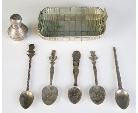 A collection of Egyptian and other silver spoons , pepperette, and a white metal basket.