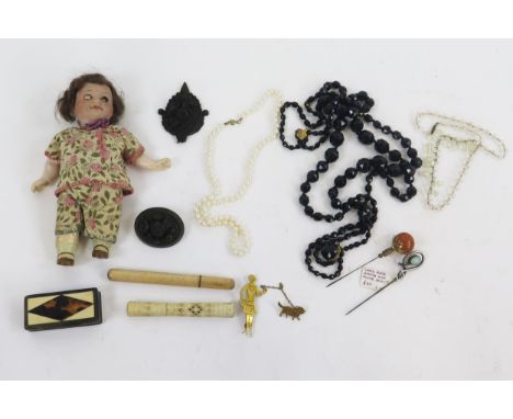 A small bisque head doll, and a quantity of costume jewellery etc.