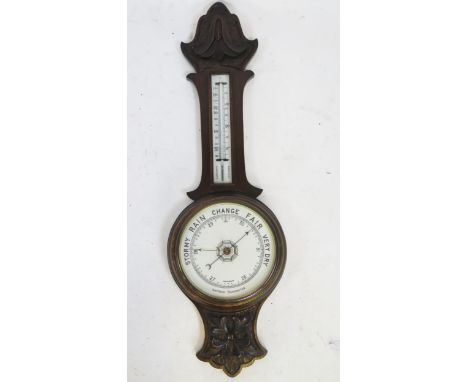 An early 20th century carved oak aneroid wheel barometer, with mercurial thermometer, 86cm high.