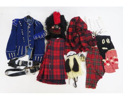 A pipers uniform, includes bonnet, kilt, tunic, sporron, bagpipe case etc.