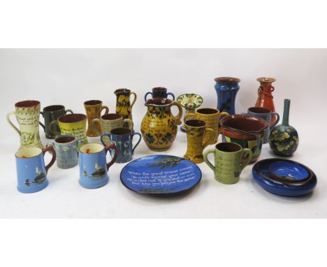 A collection of Torquay pottery, Watcombe pottery and other wares, includes vases, jugs, toby jugs, flower baskets etc.