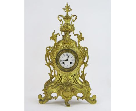 A 19th century style brass mantel clock, of arched outline with urn finial, having an 8cm enamel dial, the French circular mo