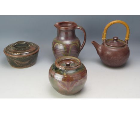 A Winchcombe Pottery Jug (20.5cm) and three unmarked pieces including a teapot, small casserole dish and ovoid jar with cover