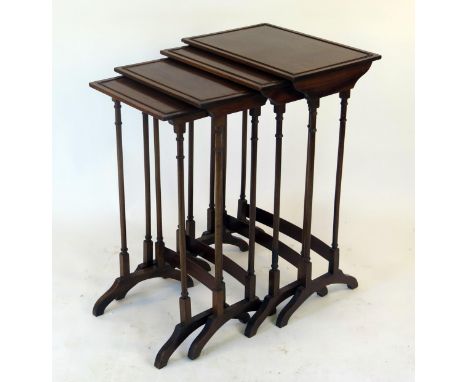 A set of mahogany quartetto tables on ring turned trestle end supports with swept feet.&nbsp; 47cms wide.