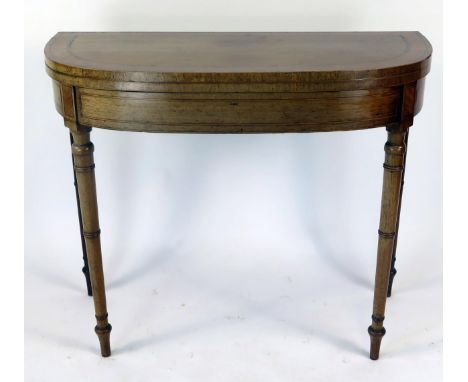 A 19th century mahogany and satinwood banded folding card table of D-shaped outline, with baize lined playing surface, raised