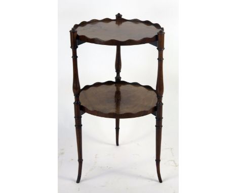 A mahogany two tier circular stand, on ring turned legs, 35cm diameter, 64cm high.