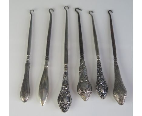 Six assorted silver handled button hooks, various makers and dates.