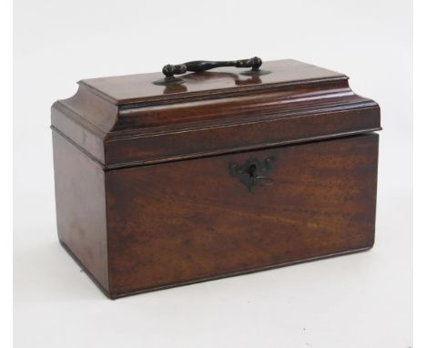 A George III mahogany tea caddy, the shallow domed top surmounted by a carrying handle enclosing three divisions to the inter