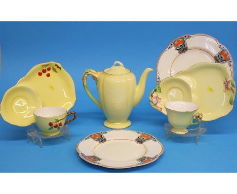 A Royal Winton 'Petunia' teapot, two cups and saucers and a pair of Woods plates