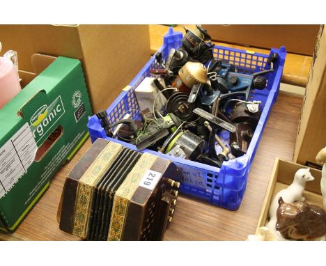 Various fishing reels and an accordion 