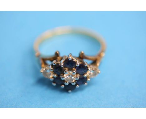 An 18ct gold diamond three stone ring set with six sapphires