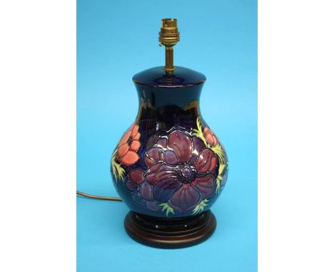 A large Moorcroft table lamp of baluster form on a blue ground decorated with poppies, 35cm height