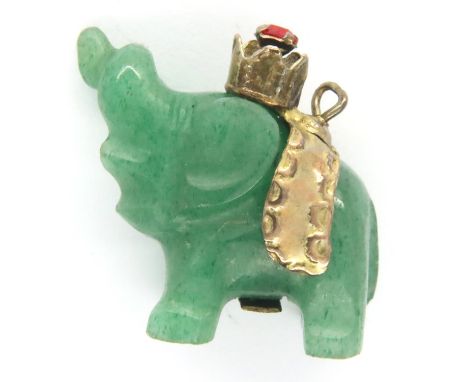 Carved jade type elephant pendant with a 14ct gold stone set band, L: 19 mm, 4.3g. P&amp;P Group 1 (£14+VAT for the first lot