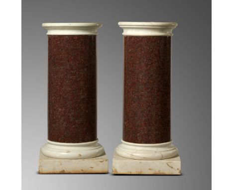 A pair of red granite column pedestals19th century
with white marble caps and bases
112cm high by 46cm diameter (top)Interior