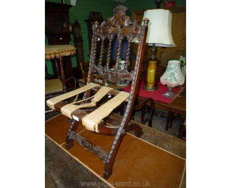 A most uncommon Mahogany folding Chair having carved detail including to the top rail, a pair of opposing sea serpents holdin