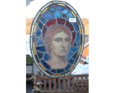 A leaded stained glass Panel, part of a larger window depicting the young Christ with a ruby glass halo, 16 1/4'' x 11 3/4'',