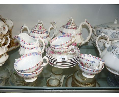 A floral pink and white hand painted Teaset to include six cups, six saucers, milk jug, sucrier and teapot.