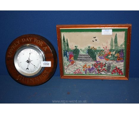 A small framed tapestry of a garden and a Guinness aneroid Barometer.