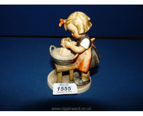 A Hummel figure, 'Doll Bath', small chip to the base.