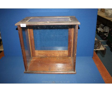 A four sided glass scientific scales Case on dark wood base. 17 1/2" tall.