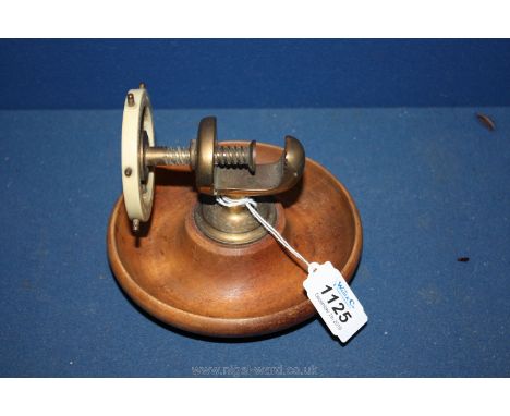 A 20th c. patent turned treen and brass Nut Cracker.