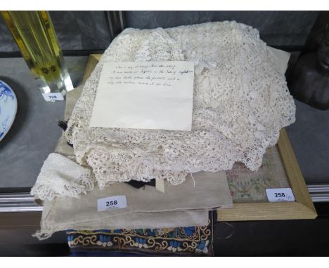 A 19th century lace table cloth, a child's lace bonnet, other textiles and a framed sampler quoting Exodus Chapter 20 