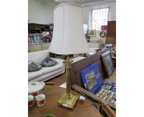 A brass column table lamp, with reeded column on a stepped square base with pad feet, 48 cm high 