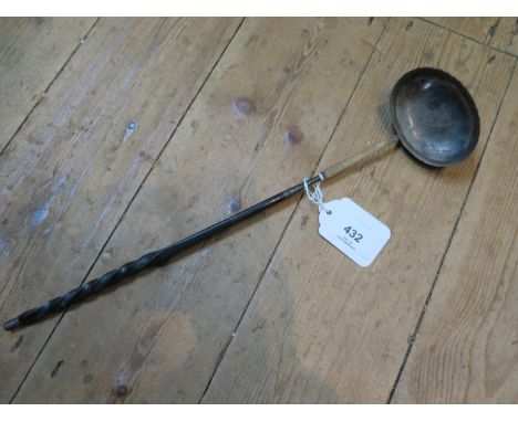 A silver toddy ladle with a 1757 coin set into the ladle base 