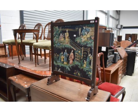 An early 20th Century firescreen having oriental fabric panel