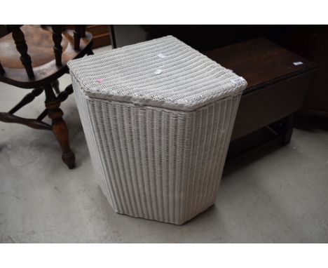 A vintage Lloyd Loom corner linen basket