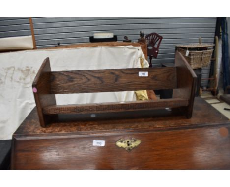 An early 20th Century oak book trough style rack