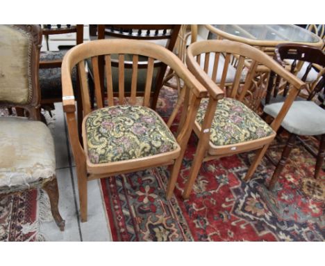 A pair of vintage bow back carver chairs