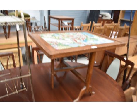 A vintage oak framed firescreen/table having tapestry panel