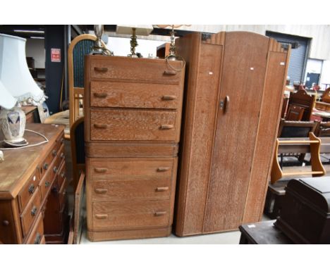 A 1930s limed oak compact bedroom suite comprising , single wardrobe, bed frame, chest of drawers and dressing table