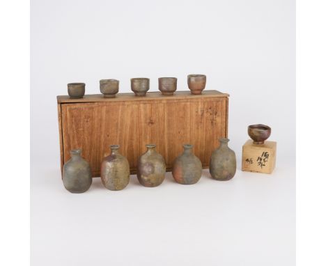 Fujiwara Yu (Japanese, 1932-2001). Set of six studio ceramic Bizen ware sake or guinomi cups and five sake bottles, 20th cent