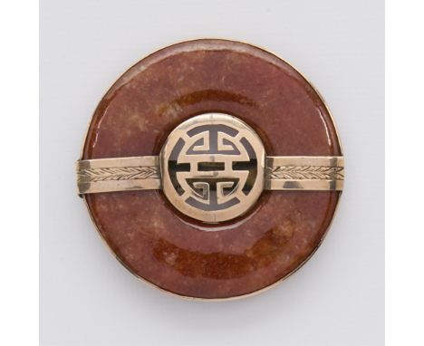 Brown jade bi set into an 18k yellow gold frame with decorative central band depicting Chinese character. The frame with two 