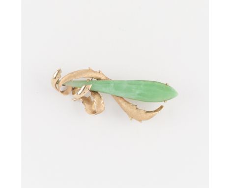 14k yellow gold and jadeite brooch. The jade an attenuated eggplant shape and the gold setting a foliate design of swirling l