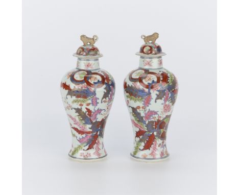 Pair Chinese porcelain lidded baluster or urn vases with tobacco leaf motifs throughout.(Each) height: 11 3/4 in x diameter: 